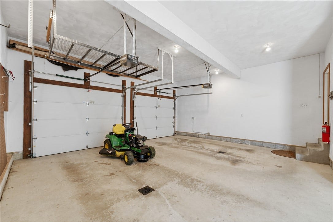 The 2 car garage has ample space for 2 cars along with an extra storage area (not pictured) across from the garage man-door that leads to the side yard.