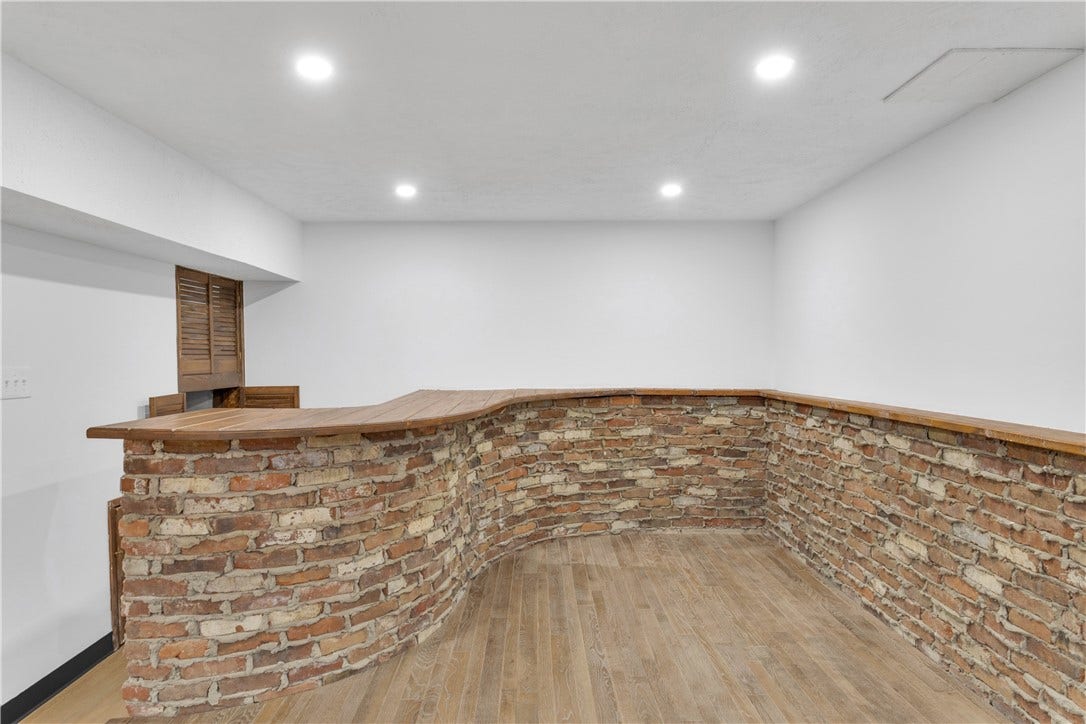 3909 Glencoe Court, Murrysville, PA 15668 Built in 13x12 Bricked Bar in the Game Room with storage and wet sink on beautiful raised wood platform.