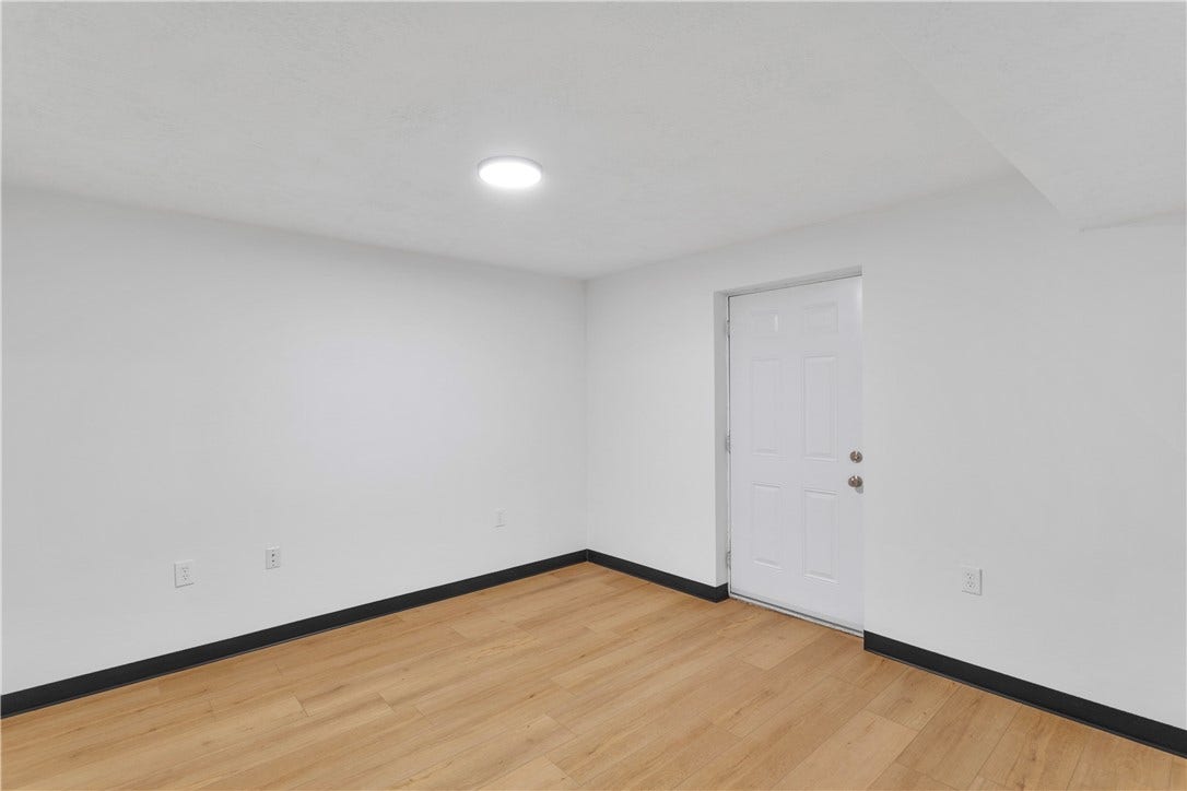 3909 Glencoe Court, Murrysville, PA 15668 Adjoining 12x12 den/sitting room off the lower level bedroom with door and walkup to the exterior.