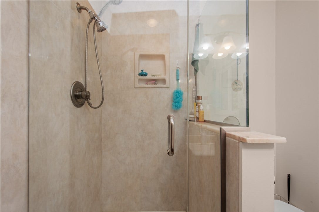 4742 Jewel Dr, Pittsburgh, PA 15236 A step-in shower with glass surround allows the light to shine in from the window on the far wall.