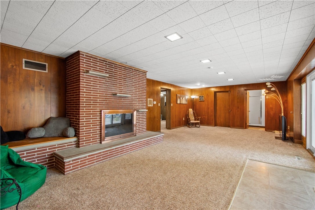 4742 Jewel Dr, Pittsburgh, PA 15236 The brick fireplace in the game room is a beautiful focal point.
