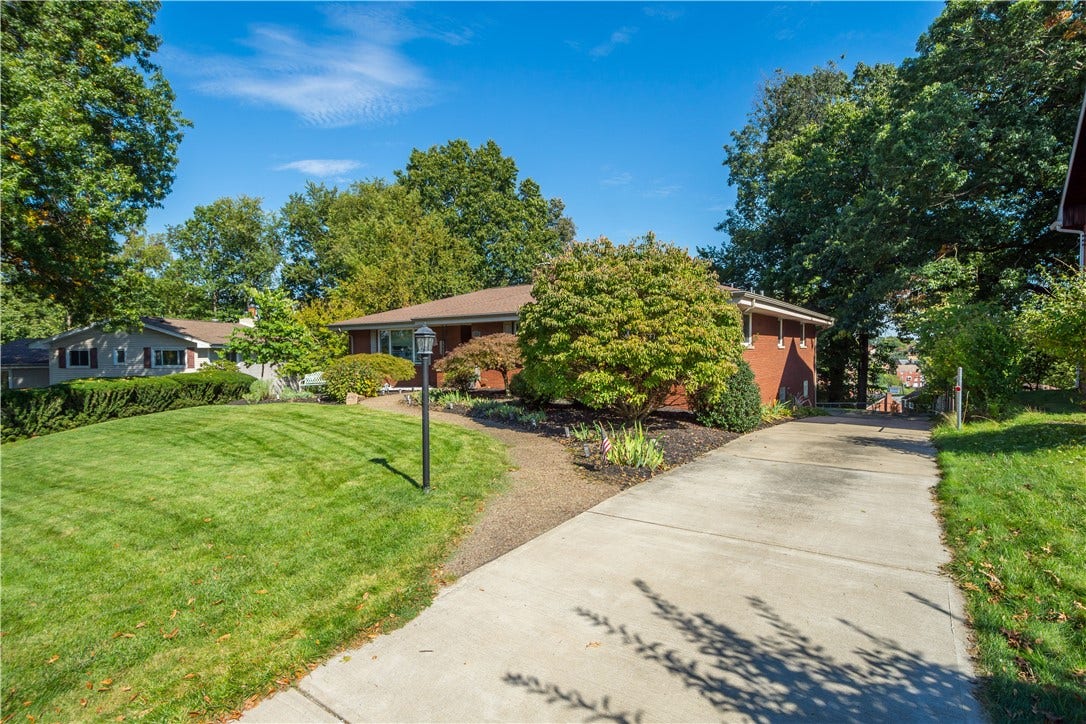 4742 Jewel Dr, Pittsburgh, PA 15236 Long driveway flows to the rear of the home where there is an integral 2-car garage.