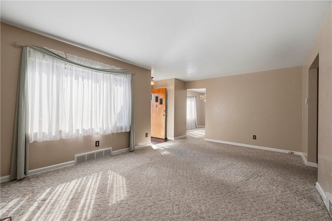 3942 Lawnview Ave, Pittsburgh, PA 15227 Living room with view of front door, entry to dining room (opening in middle)