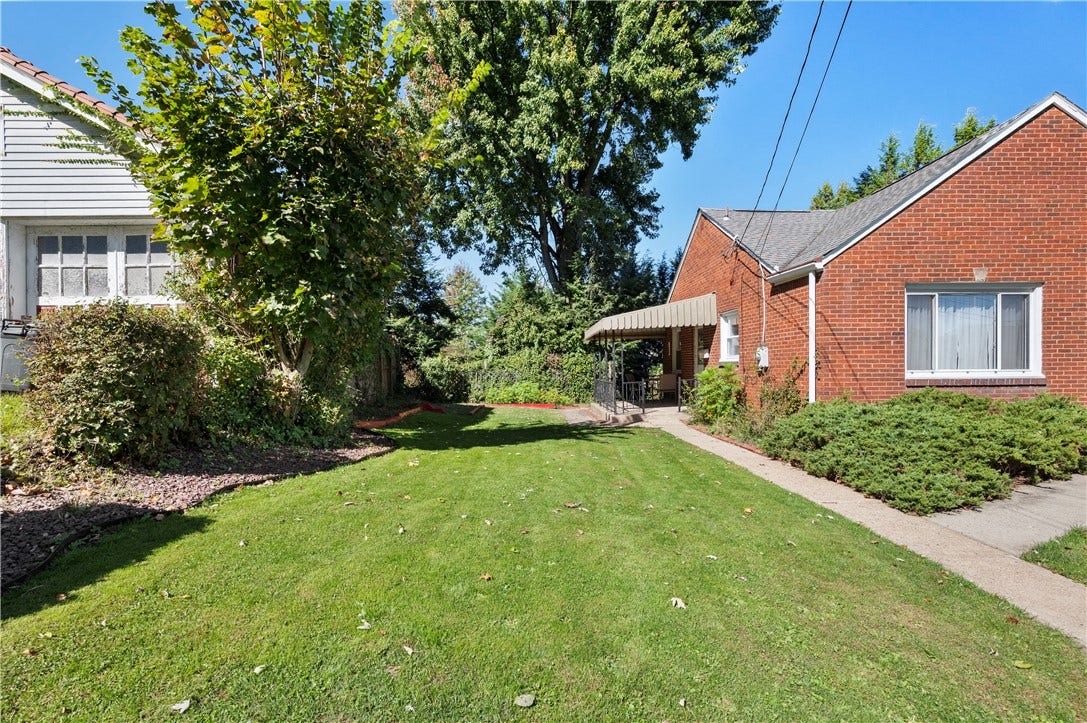 3942 Lawnview Ave, Pittsburgh, PA 15227 Left side of home with beautiful yard and relaxing covered porch