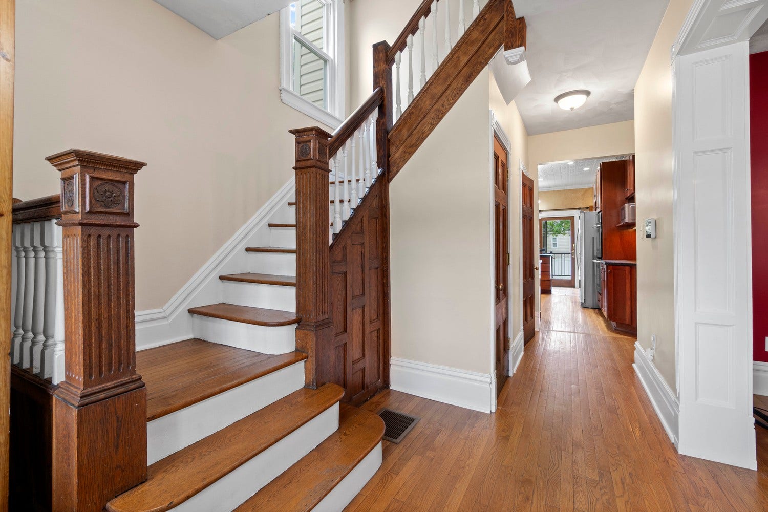 Looking from the front doors down the hallway into the kitchen.