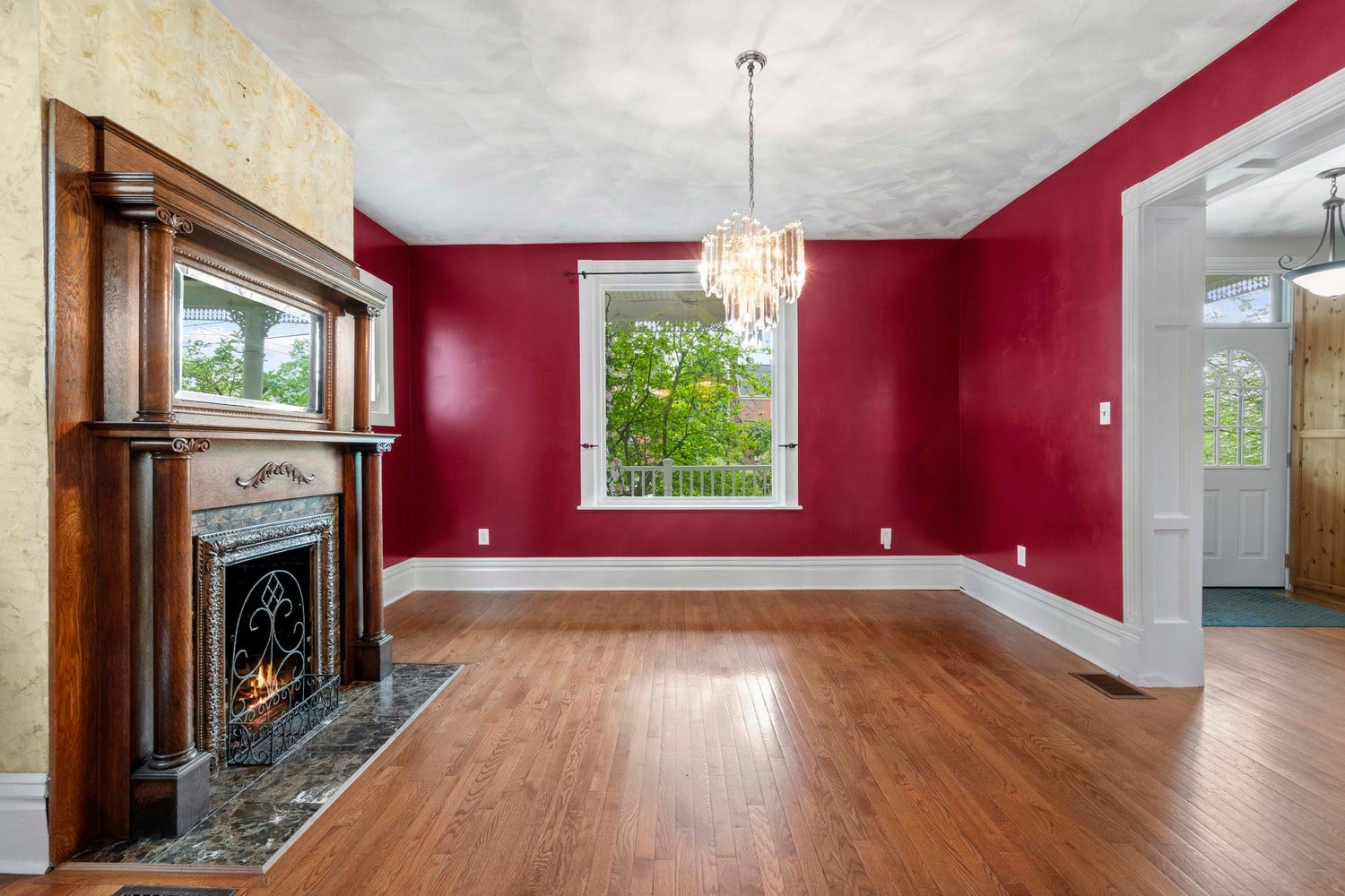 The decorative fireplace with the antique mantle surround topped with a mirror create a focal point inthe living room.