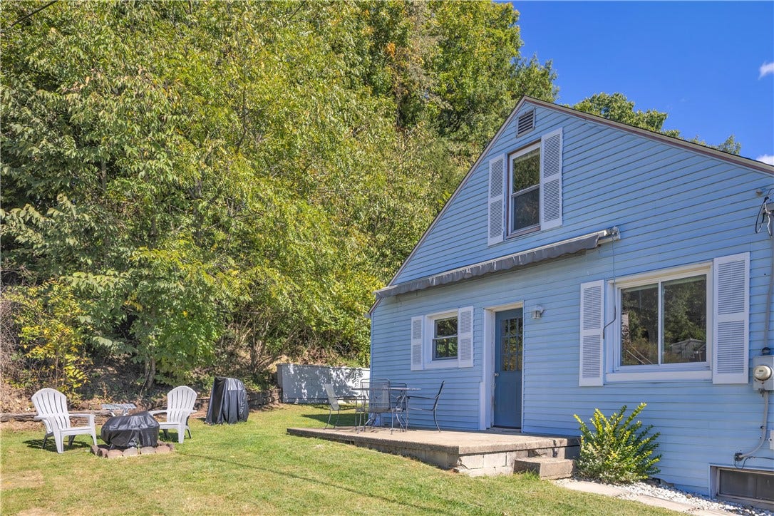136 N Hazen Ave., Ellwood City, PA 16117 The flat side yard is perfect for gatherings, complete with a cozy fire pit and retractable awning.