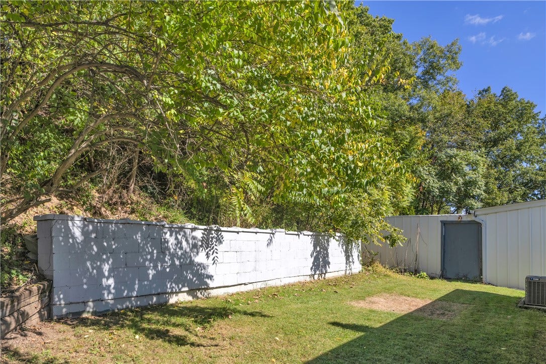 136 N Hazen Ave., Ellwood City, PA 16117 The quiet backyard feels like a private escape tucked among mature trees.