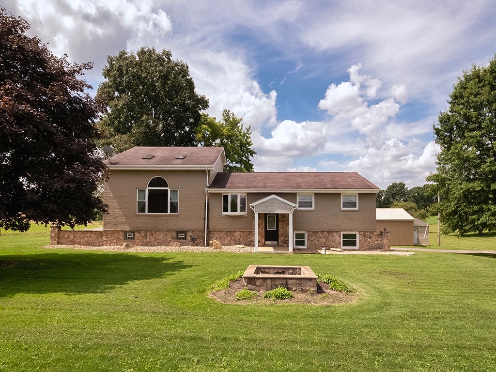 Spacious split entry home with an addition of a 2-story family room and 2nd level primary suite on a beautifully manicured 1 acre country lot