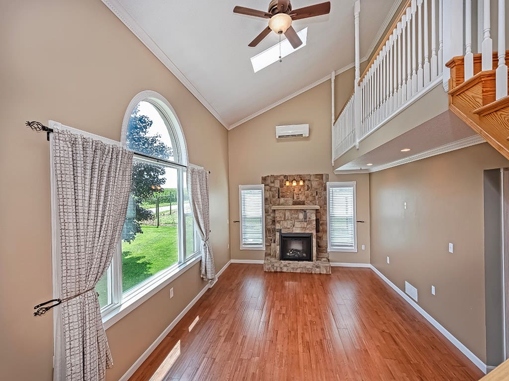 Grand 2-story great rm with fireplace and skylights